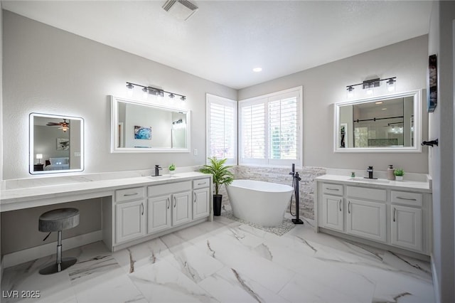 11112 Pine Greens Ct, Las Vegas, NV 89144 - bathroom featuring a soaking tub, two vanities, a shower, recessed lighting, and marble finish floors