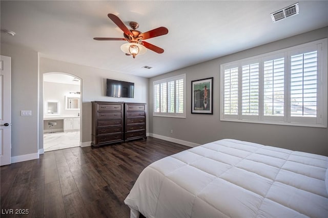 11112 Pine Greens Ct, Las Vegas, NV 89144 - bedroom featuring dark wood-style flooring, baseboards, arched walkways, and ensuite bath