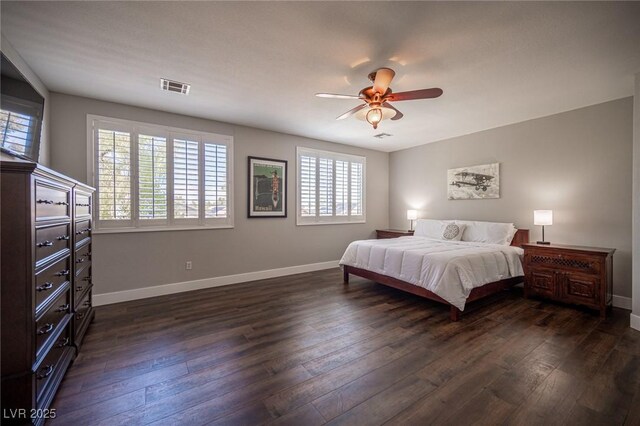11112 Pine Greens Ct, Las Vegas, NV 89144 - bedroom featuring multiple windows, dark wood-style floors, and baseboards