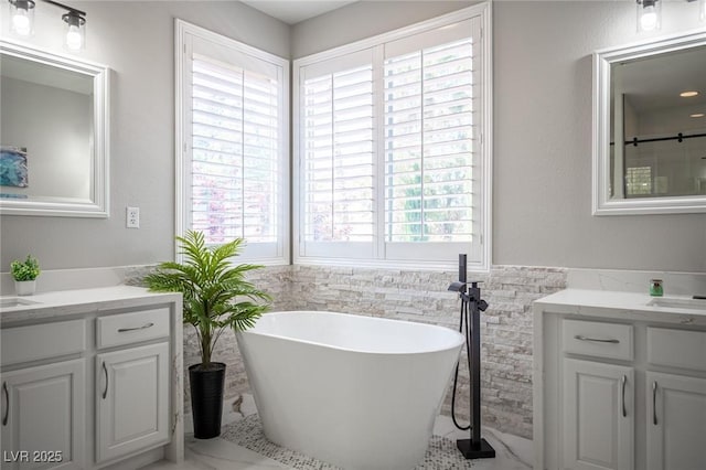 11112 Pine Greens Ct, Las Vegas, NV 89144 - bathroom with a freestanding bath, two vanities, tile walls, a wainscoted wall, and marble finish floors