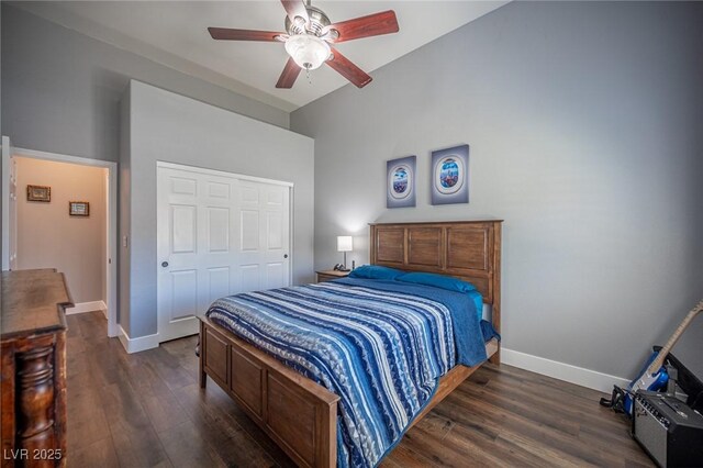 11112 Pine Greens Ct, Las Vegas, NV 89144 - bedroom featuring dark wood-style floors, a closet, baseboards, vaulted ceiling, and a ceiling fan