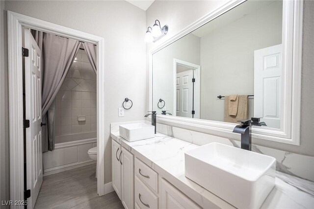 11112 Pine Greens Ct, Las Vegas, NV 89144 - bathroom with toilet, wood finished floors, double vanity, and bathing tub / shower combination