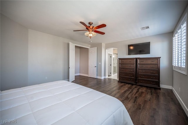 11112 Pine Greens Ct, Las Vegas, NV 89144 - bedroom with arched walkways, dark wood-style flooring, baseboards, and ensuite bathroom