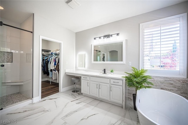 11112 Pine Greens Ct, Las Vegas, NV 89144 - bathroom featuring a stall shower, marble finish flooring, a freestanding tub, and plenty of natural light
