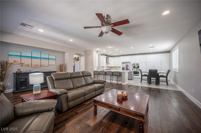 11112 Pine Greens Ct, Las Vegas, NV 89144 - living area featuring ceiling fan, arched walkways, recessed lighting, dark wood-type flooring, and baseboards