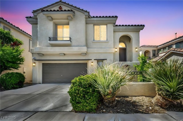 11908 Menchaca Ln, Las Vegas, NV 89138 - mediterranean / spanish house featuring a tile roof, an attached garage, driveway, and stucco siding