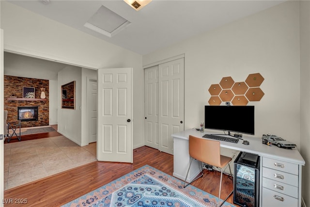 11908 Menchaca Ln, Las Vegas, NV 89138 - office with wood finished floors, a fireplace, attic access, and baseboards