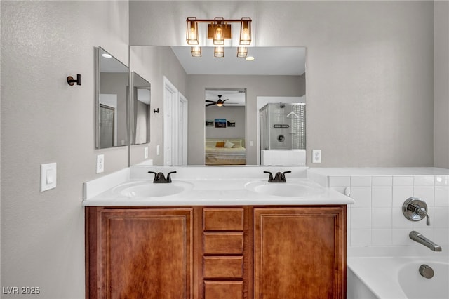 11908 Menchaca Ln, Las Vegas, NV 89138 - bathroom featuring ceiling fan, a bath, double vanity, and a shower with shower door