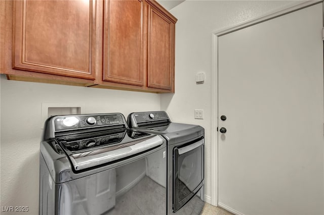 11908 Menchaca Ln, Las Vegas, NV 89138 - laundry area featuring separate washer and dryer, cabinet space, and light tile patterned floors