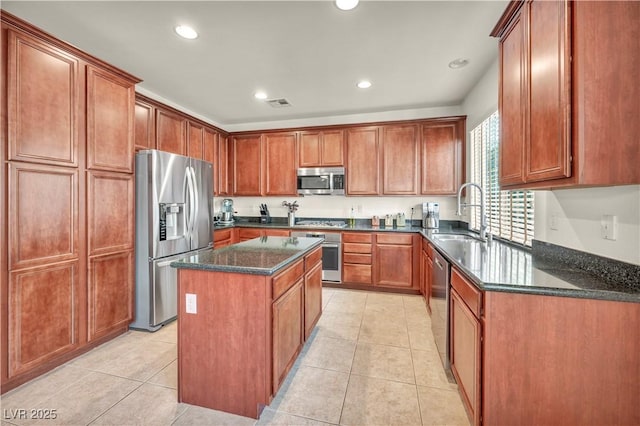 11908 Menchaca Ln, Las Vegas, NV 89138 - kitchen featuring appliances with stainless steel finishes, a sink, a kitchen island, dark stone countertops, and light tile patterned floors