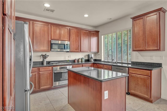 11908 Menchaca Ln, Las Vegas, NV 89138 - kitchen with stainless steel appliances, a sink, light tile patterned floors, a kitchen island, and recessed lighting