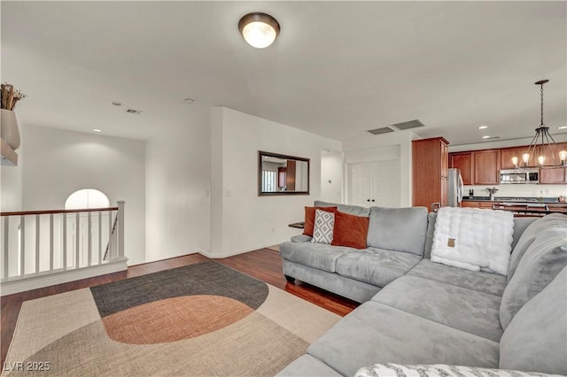 11908 Menchaca Ln, Las Vegas, NV 89138 - living area with a chandelier, dark wood-style flooring, baseboards, and recessed lighting