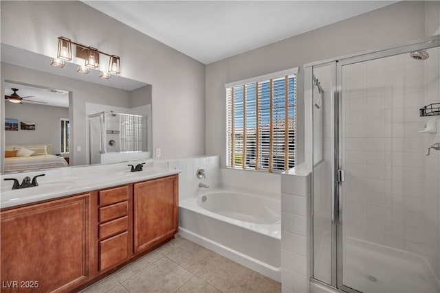 11908 Menchaca Ln, Las Vegas, NV 89138 - ensuite bathroom with a garden tub, a stall shower, tile patterned flooring, double vanity, and ceiling fan