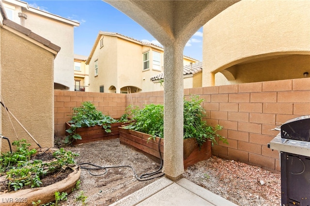 4533 Lime Straight Dr, Las Vegas, NV 89115 - view of patio with a garden, fence, and a grill