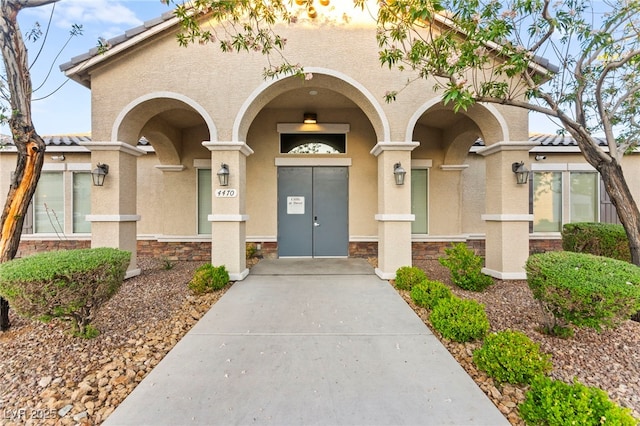 4533 Lime Straight Dr, Las Vegas, NV 89115 - entrance to property featuring stucco siding, a tile roof, and stone siding