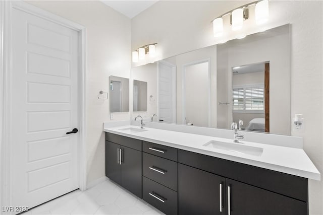 717 Monroe Hill Pl, Henderson, NV 89011 - bathroom with connected bathroom, double vanity, tile patterned floors, and baseboards