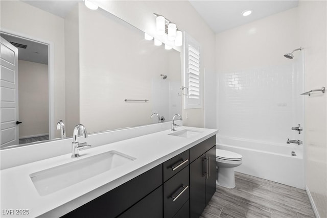 717 Monroe Hill Pl, Henderson, NV 89011 - bathroom featuring toilet, washtub / shower combination, wood finished floors, and double vanity