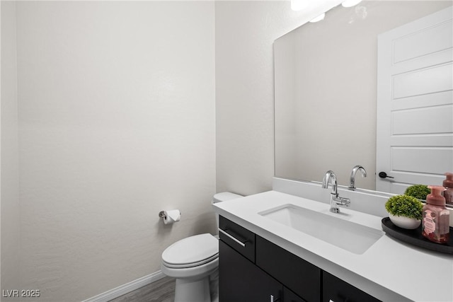 717 Monroe Hill Pl, Henderson, NV 89011 - bathroom with baseboards, vanity, toilet, and wood finished floors