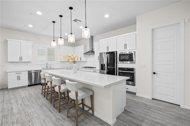 717 Monroe Hill Pl, Henderson, NV 89011 - kitchen with stainless steel appliances, wall chimney exhaust hood, a sink, tasteful backsplash, and recessed lighting
