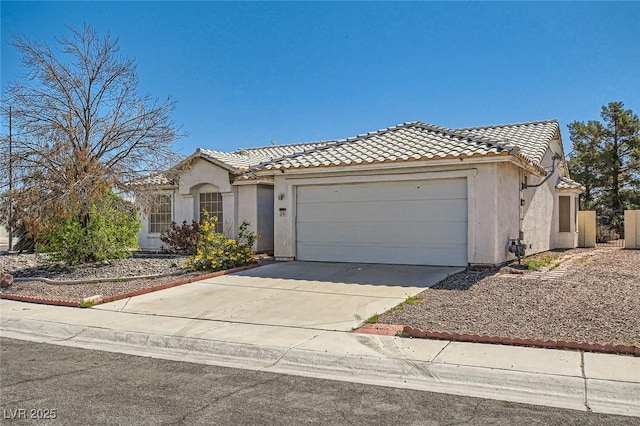 3912 Branchwood Dr, North Las Vegas, NV 89032 - mediterranean / spanish-style house with a tile roof, an attached garage, stucco siding, and driveway