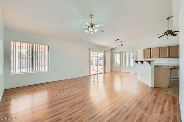 3912 Branchwood Dr, North Las Vegas, NV 89032 - unfurnished living room featuring ceiling fan, light wood-style floors, vaulted ceiling, and baseboards