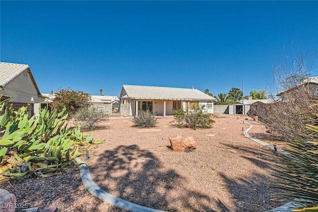 3912 Branchwood Dr, North Las Vegas, NV 89032 - rear view of property with a shed, an outdoor structure, a tile roof, fence, and stucco siding