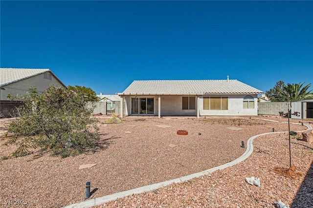 3912 Branchwood Dr, North Las Vegas, NV 89032 - rear view of property with fence, stucco siding, and a tile roof