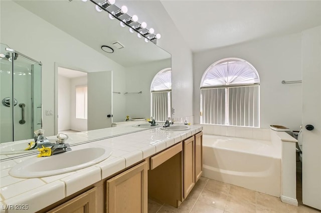 3912 Branchwood Dr, North Las Vegas, NV 89032 - bathroom with plenty of natural light, lofted ceiling, a bath, double vanity, and a stall shower