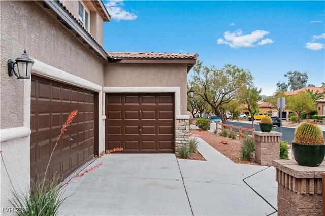 garage with concrete driveway