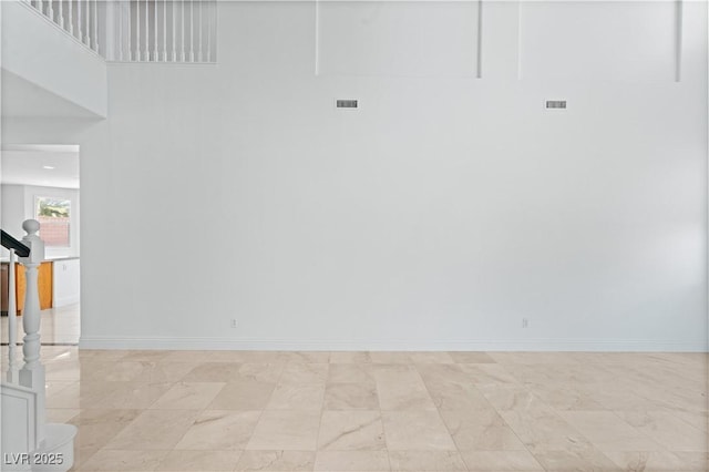 spare room with baseboards