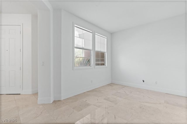 empty room featuring baseboards