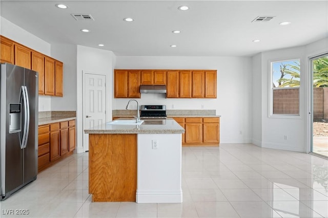 kitchen featuring stainless steel appliances, under cabinet range hood, a sink, recessed lighting, and light tile patterned floors