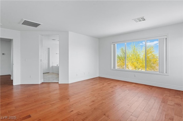 unfurnished room featuring light wood-type flooring and baseboards