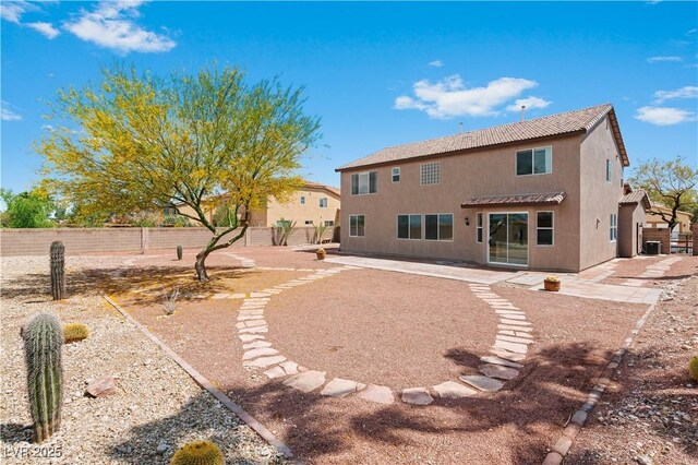 back of property featuring stucco siding, a patio, and fence