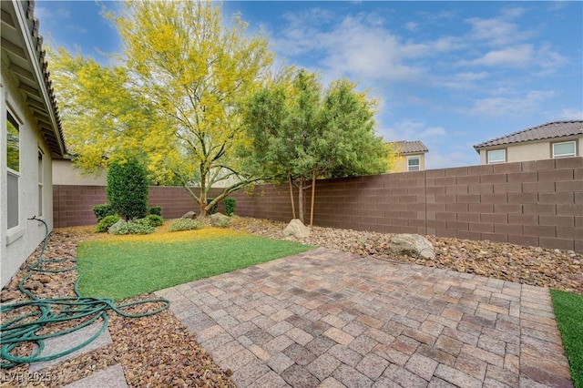 fenced backyard with a patio area