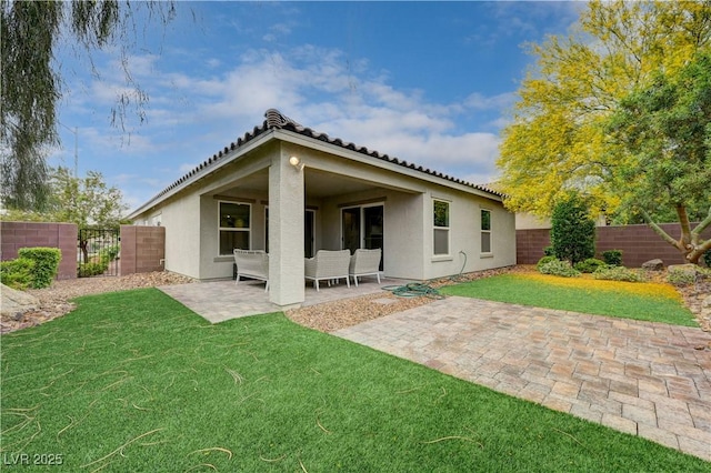 rear view of property with stucco siding, a patio, and a tiled roof