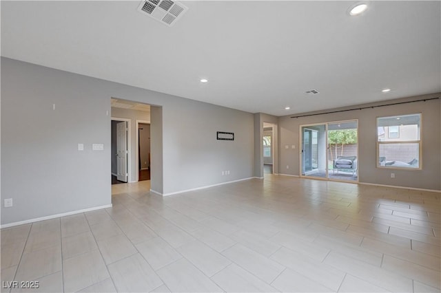 empty room featuring recessed lighting and baseboards