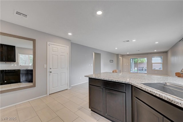 kitchen featuring black dishwasher, healthy amount of natural light, light tile patterned floors, recessed lighting, and a sink