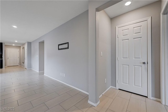 foyer entrance featuring baseboards and recessed lighting