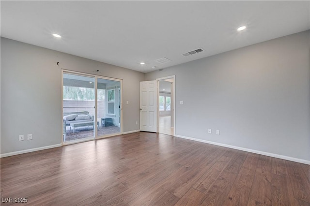 unfurnished room featuring baseboards, wood finished floors, and recessed lighting