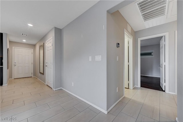 hallway featuring recessed lighting and baseboards