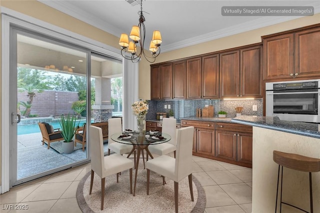 7505 Java Sparrow St, North Las Vegas, NV 89084 - kitchen featuring oven, light tile patterned floors, decorative backsplash, ornamental molding, and pendant lighting