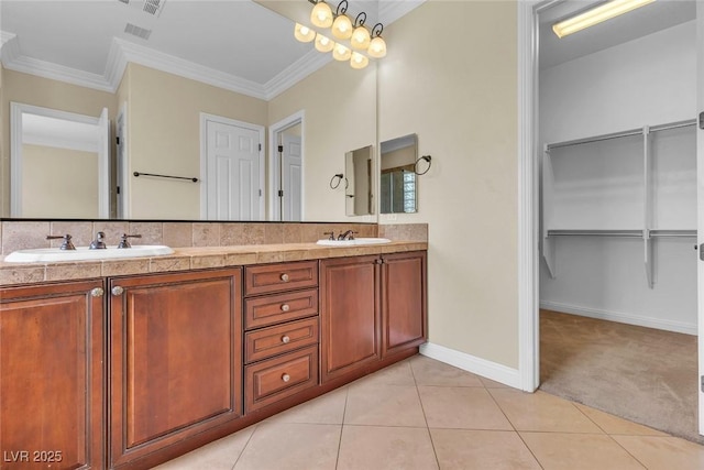 7505 Java Sparrow St, North Las Vegas, NV 89084 - bathroom featuring double vanity, crown molding, baseboards, tile patterned flooring, and a spacious closet