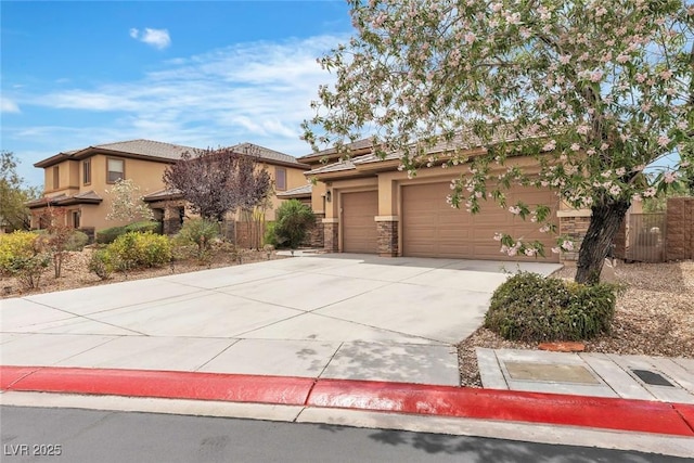 7505 Java Sparrow St, North Las Vegas, NV 89084 - view of front of house featuring concrete driveway, stucco siding, a garage, and stone siding