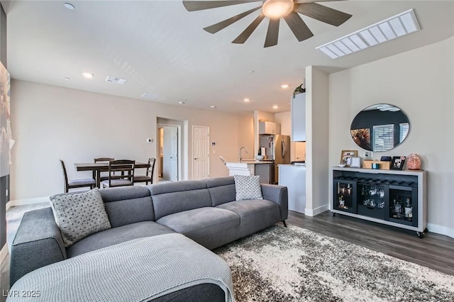 living room with a ceiling fan, dark wood-style floors, baseboards, and recessed lighting