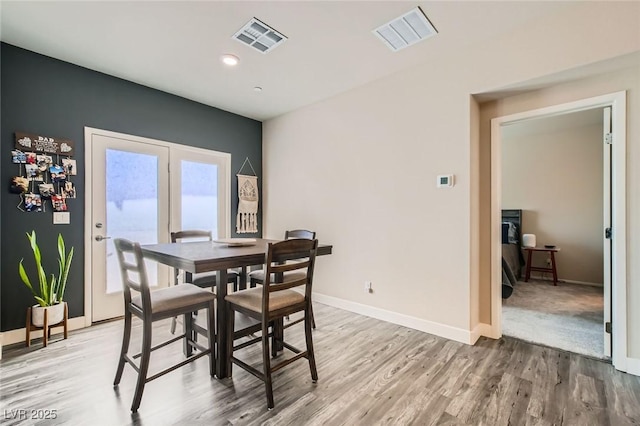 dining space with wood finished floors and baseboards