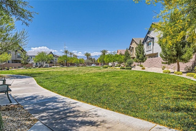 view of home's community featuring a residential view and a yard