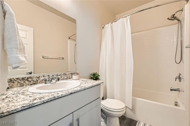 bathroom with toilet, vanity, shower / bath combo with shower curtain, and wood finished floors