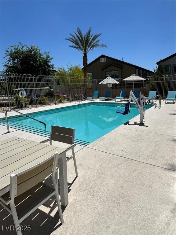 view of pool featuring a patio area and fence