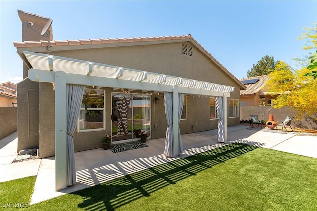 rear view of property with a patio, a pergola, and stucco siding